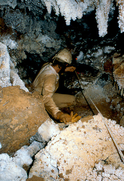Apple Green surveying in stream passage under Krakatoa Cango
